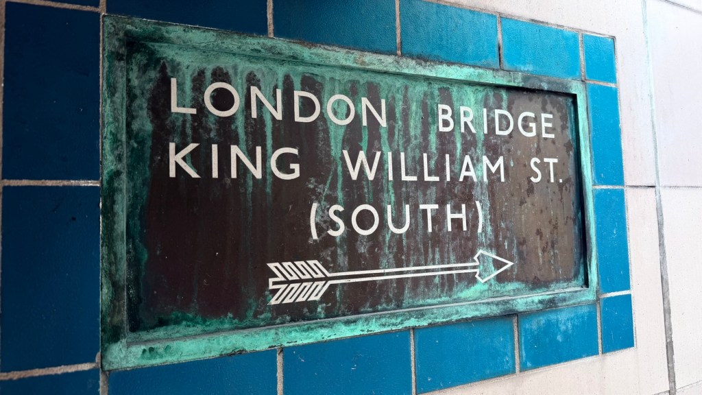 Wall sign at Monument station pointing to London Bridge and King William Street south.